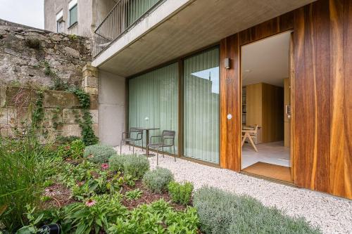 a glass door of a building with a table and chairs at DPV Residences - Studio CA/C1 in Porto