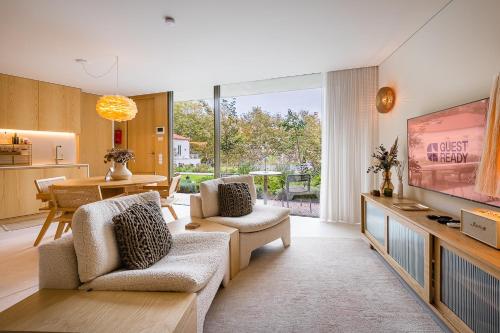 a living room with a television and a dining room at DPV Residences - Studio CA/C1 in Porto