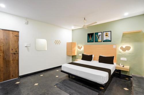 a bedroom with a bed and a desk in it at Hotel O The Bell Woods in Mūrhīpār