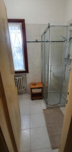 a bathroom with a shower with a glass door at Appartamento Santa Sofia in Padova