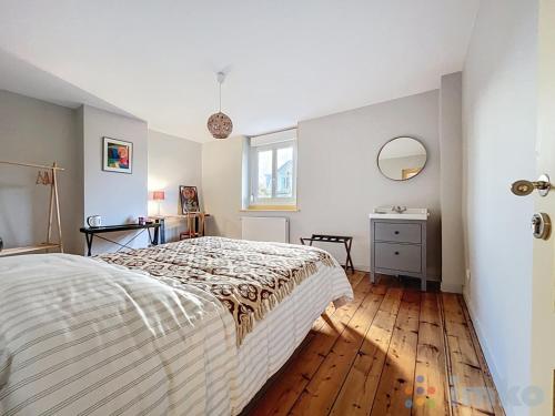 a bedroom with a bed and a wooden floor at Anavel Atao in Lille