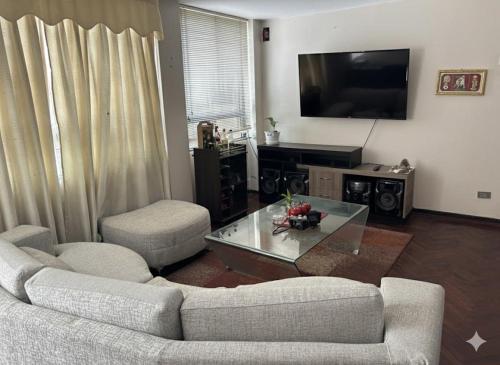 a living room with a couch and a coffee table at Hostel Wayra Wasi in Lima
