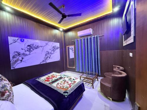 a bedroom with a bed and a ceiling fan at The Hotel Moon in Pāonta Sāhib