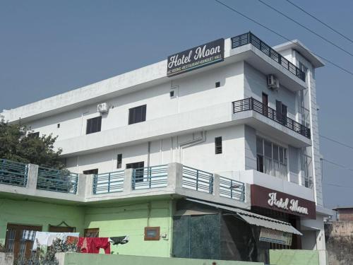 a white building with a sign on top of it at The Hotel Moon in Pāonta Sāhib