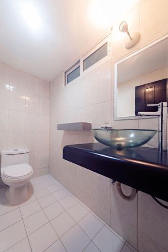 a bathroom with a sink and a toilet at Hotel CARPE DIEM Tulum by Nah Hotels in Tulum
