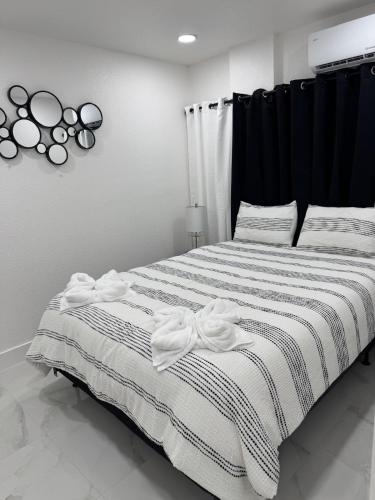a bedroom with a bed with a black and white blanket at Apartment in Tampa