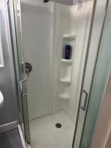 a shower with a glass door in a bathroom at Guest house 7 mins From stadium in Opa-locka