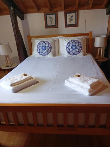 a bed with two towels on top of it at Ribeira da Praia House in Vila Franca do Campo