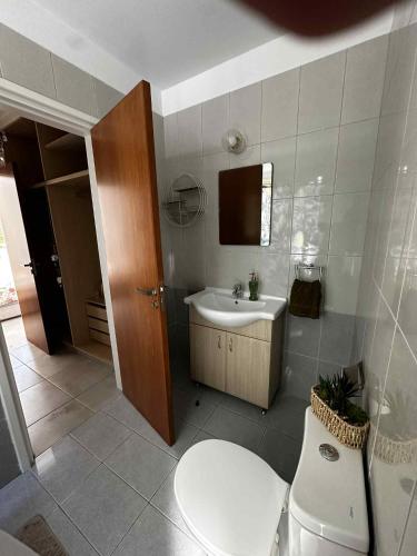 a bathroom with a toilet and a sink at Aphrodites Resident in Paphos