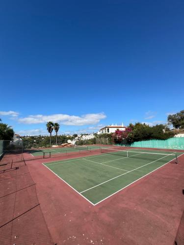 a tennis court with two tennis rackets on it at Casa Julio in Carvoeiro
