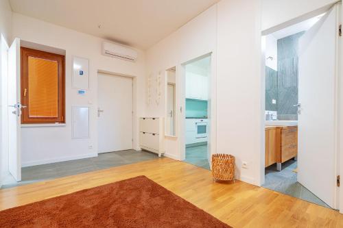 an empty living room with white walls and wooden floors at B-Home Apartments in Trenčín