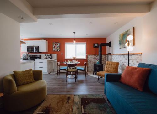 a living room with a blue couch and a table at eARTh studios GallerySuite in Nelson