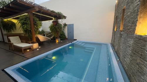 a swimming pool with a table and a pavilion at Condominio Panamá in Puerto Vallarta