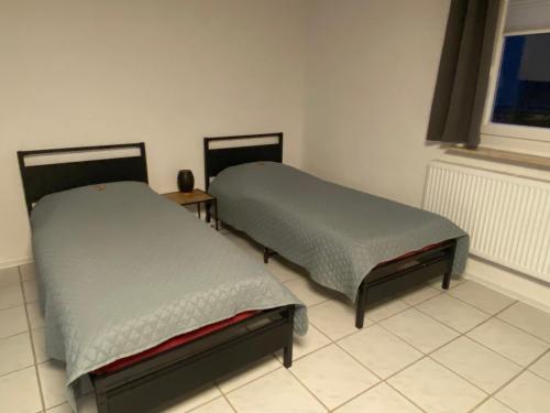 Postel nebo postele na pokoji v ubytování Ruhiges Apartment nahe Innenstadt und Kliniken