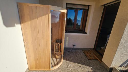 a wooden cabinet in a room with a window at Apartment Wanderlust Gerlitzen in Kanzelhöhe