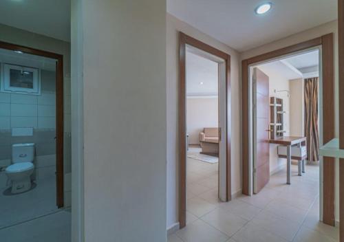 a room with a bathroom with a toilet and a bedroom at Dora Thermal Tatil Köyü & Spa in İhsaniye