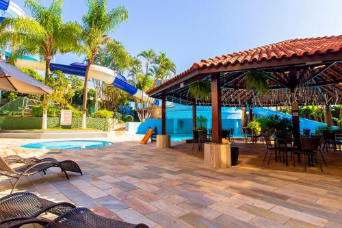 a patio with a water slide and a pool at Hotel Vilage Inn Ribeirão Preto & Convenções by Nacional Inn in Ribeirão Preto