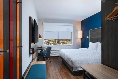 a hotel room with a bed and a window at Tru By Hilton Irving Dfw South in Irving