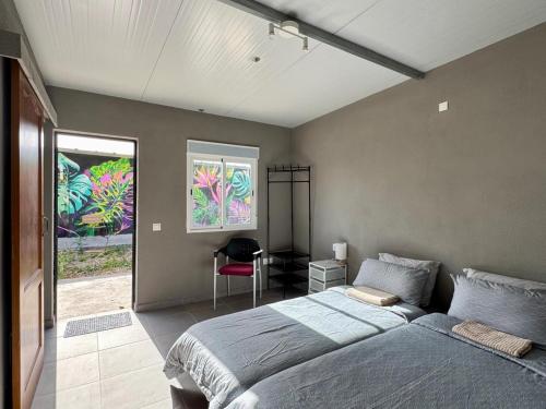 a bedroom with a bed and a desk in it at Fathill Finca in Tamaide