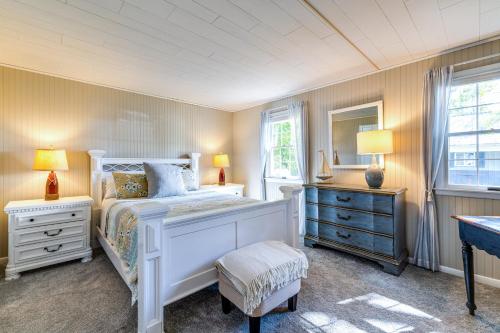 a bedroom with a white bed and two night stands at Wilson Waterfront Getaway Near Hikes and Wineries! in Wilson