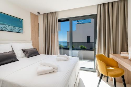 a bedroom with two beds and a large window at Luxury Villa Helena, with heated pool in Makarska