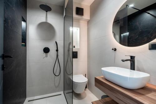 a bathroom with a sink and a shower at Luxury Villa Helena, with heated pool in Makarska