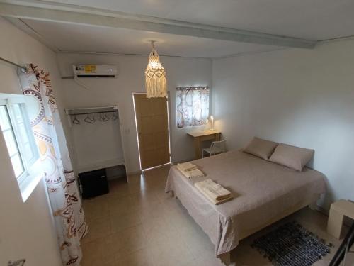 a bedroom with a large bed and a window at cabanita Celeste in Boca Chica