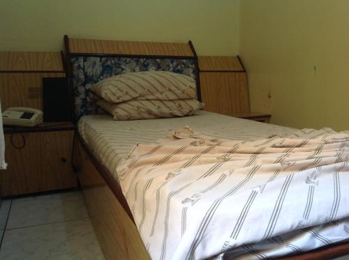 Ένα ή περισσότερα κρεβάτια σε δωμάτιο στο Hotel Bali