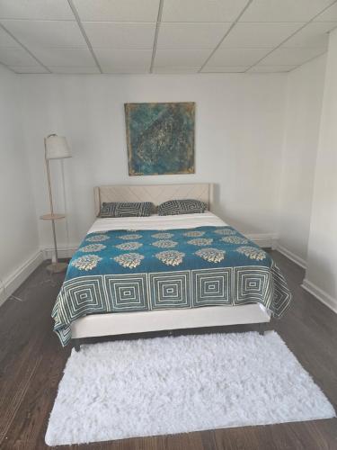 a bedroom with a bed and a rug on the floor at Cozy Getaway in Kearny