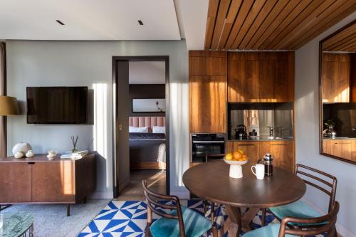 a kitchen and dining room with a table and chairs at Native Bankside in London