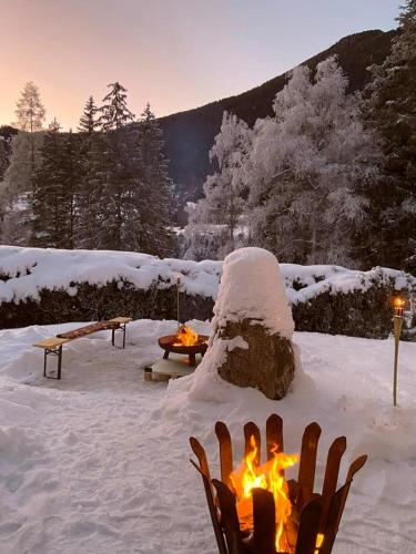 a snow covered yard with a fire in the snow at Ferienwohnung Chow Chow in Nauders