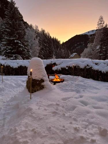 a snow covered yard with a fire in the snow at Ferienwohnung Mops in Nauders