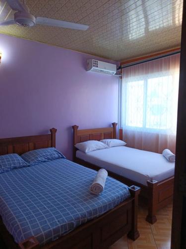 a bedroom with two beds and a window at BnB in Mombasa