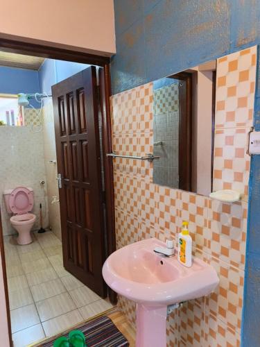 a bathroom with a sink and a toilet at BnB in Mombasa