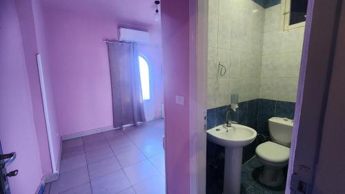 a bathroom with a toilet and a sink at Shapon Hotel - Hurghada in Hurghada