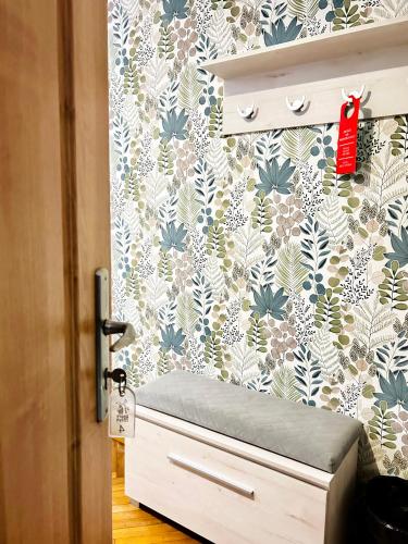 a room with a drawer and a wall with floral wallpaper at Stary Młyn in Żory