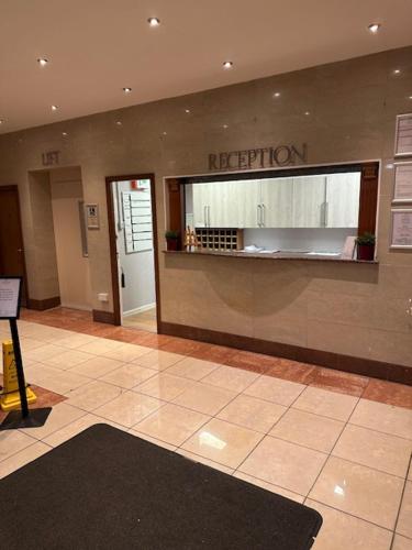 an empty lobby with a reception desk in a building at west park hotel PVT ltd in Clydebank