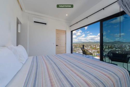 a bedroom with a bed and a large window at Amazing Apt with City View - Rooftop Pool in Los Médanos Partidos