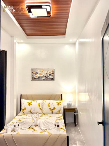 a bedroom with a bed with yellow leaves on it at CJ Apartments-III in Olongapo