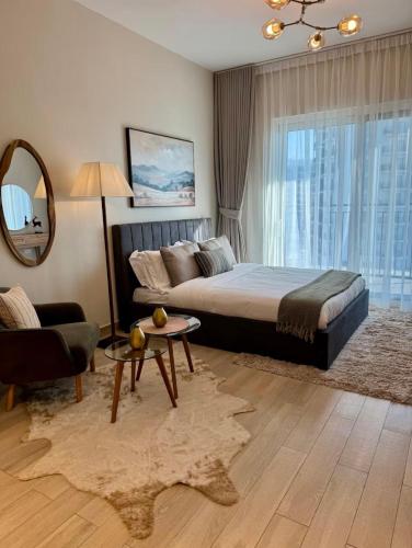a bedroom with a bed and a couch and a mirror at Chez Teo in Abu Dhabi