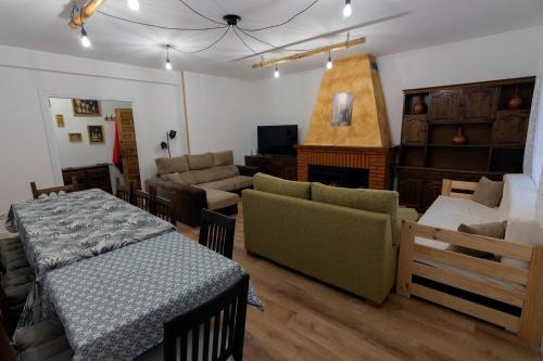 a living room with a table and a couch at El Salón de Arriba in El Real de San Vicente