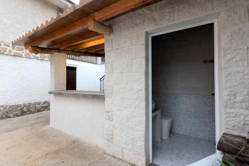an outdoor bathroom with a toilet in a building at El Salón de Arriba in El Real de San Vicente