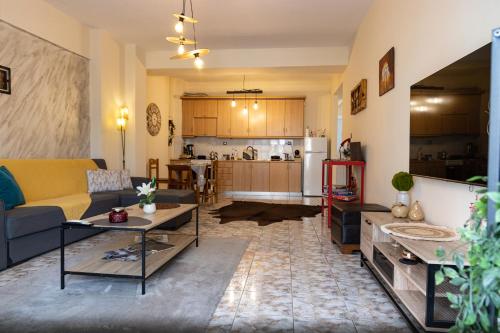 a living room with a couch and a kitchen at Comfort Zone - Spacious Apartment in Xanthi in Xanthi