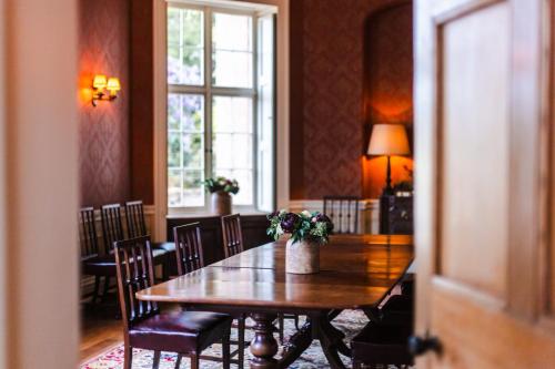 a dining room with a wooden table and chairs at The Citadel in Weston