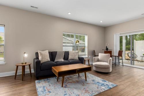 a living room with a couch and a table at Modern 2BR & 2BA New Build Condo w Garage & Patio in Grandville