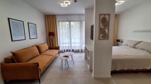 a living room with a couch and a bed at Lavén Superior Apartment in Balatonfüred