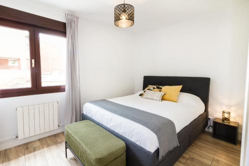 a bedroom with a bed and a window at Etxea iradi in Elejalde