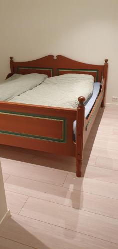 a bed sitting on top of a wooden floor at Tromsø, Skarvegen 18, two bedrooms in Tromsø