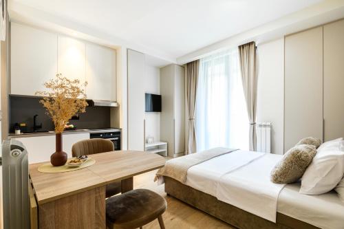 a hotel room with a bed and a dining table at inJoy in Belgrade