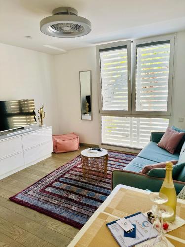 a living room with a blue couch and a table at AMBER APARTMENTS - PINK STUDIO in Morro del Jable